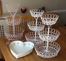 white wire baskets on a table with a heart shaped bowl and other items in the background