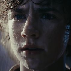 a close up of a child with water on his face