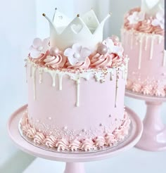 two cakes decorated with pink frosting and white icing, one has a crown on top