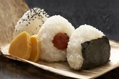 sushi is served on a plate with sesame seeds