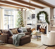 a living room filled with furniture and christmas decorations