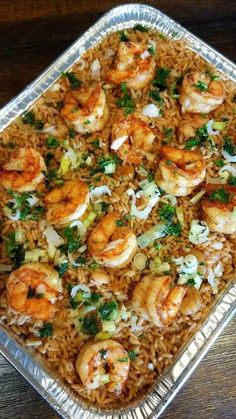 shrimp and rice with parsley in a pan on a wooden table top, ready to be eaten