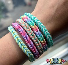 multicolored braid bracelets on someone's arm