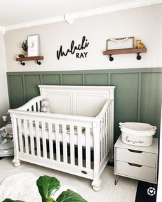 a white crib in a green and white nursery