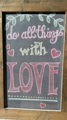 a chalkboard with the words do all things with love written on it