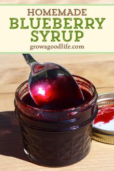 homemade blueberry syrup in a jar with spoon