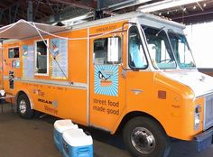 an orange food truck parked in a warehouse