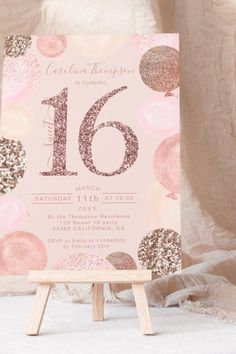 a pink and gold 16th birthday party with confetti on the table next to a easel