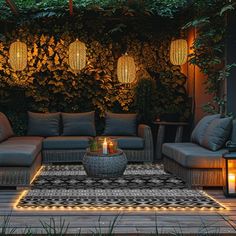 an outdoor living area with couches and lights