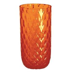 an orange glass vase sitting on top of a table