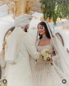 the bride and groom are smiling at each other