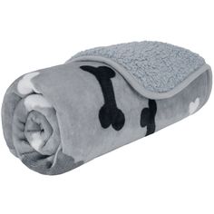 a gray blanket with black and white designs on the bottom, rolled up in half