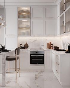 a kitchen with white cabinets and marble counter tops