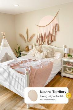 a white bed sitting in a bedroom next to a pink blanket on top of it