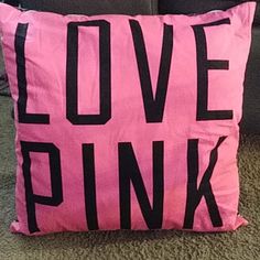 a pink pillow that says love pink on it