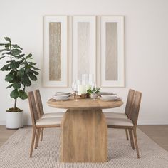 a dining room table with chairs and plates on top of it in front of three framed pictures