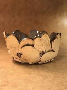 a bowl with flowers on it sitting on a table