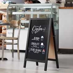 a chalk board sign in front of a bakery