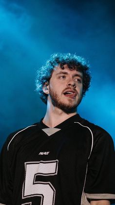 a man with blue hair wearing a football uniform