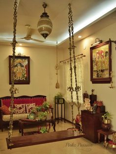 a living room filled with furniture and hanging decorations