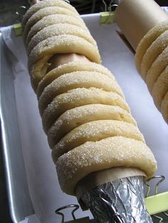 an ice cream sandwich is being made on a stick and wrapped in tin foil with a knife