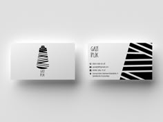 a white business card with black and white stripes on the front, and back side