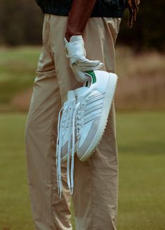 a close up of a person holding a tennis shoe