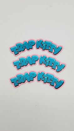 three stickers with the words trap kitty, trap kitty and trap kitty on them