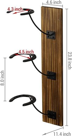 the wall mounted coat rack has three hooks on it and is made from wood with black iron