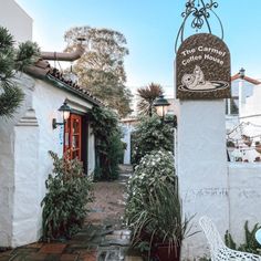 the entrance to the coffee house is surrounded by greenery and potted planters