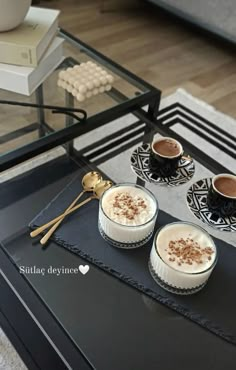 three desserts are sitting on a table with spoons and cups in front of them