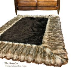 a fur rug is on the floor next to a leather couch