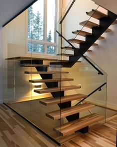 a wooden and glass staircase in a house