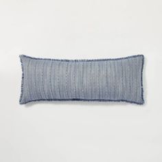 a blue striped pillow on a white background