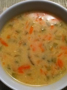 a white bowl filled with soup on top of a table