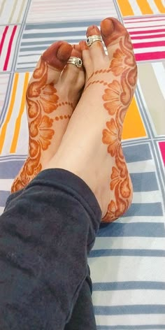 a woman's feet with hennap on top of her leg and toe