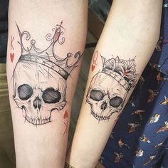 two people with tattoos on their arms and one has a skull wearing a tiara