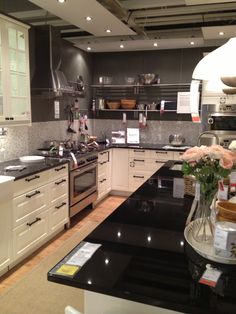 a kitchen with black counter tops and white cabinets