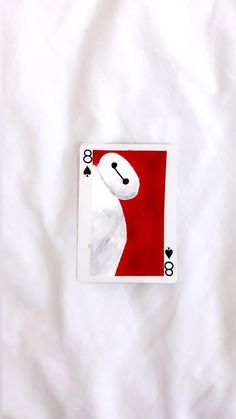 a playing card laying on top of a white sheet