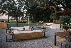 an outdoor seating area with couches and tables