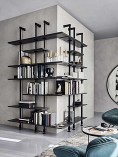 a living room filled with furniture and a book shelf next to a wall mounted mirror