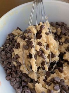 a white bowl filled with chocolate chip cookie dough