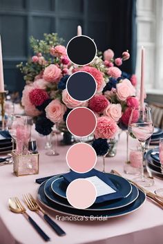 the table is set with pink and black plates, silverware, candles, and flowers