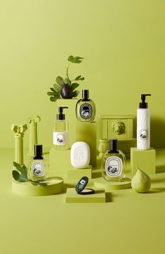 various green and white bathroom items on a yellow surface with a plant in the corner