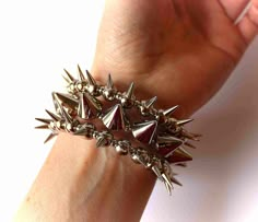 Spike Bracelet, Silver Spike Bracelet, Punk Spike Bracelet, Punk Rock Bracelet, Gothic Bracelet, Gothic Jewelry, Stud Punk Rock Bracelet, Spike Goth Jewelry Punk cuff bracelet made of silver plastic spikes and beads. The beads are strung on hard memory wire in 3 rows. This bracelet is adjustable and it wraps around the wrist like a spiral. See the last photo and choose your size spiral wire with the option. ♥ Unique design & handmade product by MimosaMilenaDobreva® #2572 ♥ If you have questi 80s Rock Jewelry, Spiky Jewelry, Spiky Bracelet, Thorn Bracelet, Bracelet Grunge, Silver Bralette, Bracelet Gothic, Emo Accessories, Spiked Jewelry