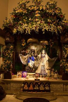 an altar decorated with flowers and figurines