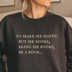 For anyone who is easily won over with books. A great sweatshirt for any bookish souls! *This sweatshirt is printed in the United States* *Made from 50% Cotton and 50% Polyester* Our sweatshirts are unisex. Please refer to the size chart in the picture for sizing.  For sweatshirt care, we recommend that you machine wash: warm; non-chlorine bleach as needed; Tumble dry: medium heat; Do not iron; Do not dry clean.  We print our sweatshirts as customers order them so we ask for your patience and un Bookish Sweatshirt With Letter Print And Crew Neck, Book Hoodies, Book Sweatshirts, Girly Christmas Gifts, Embroider Ideas, Book Cafe, Book Clothes, Cute Shirt Designs, Gifts For Bookworms