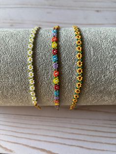 three beaded bracelets sitting on top of each other