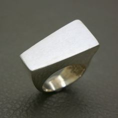 This Vintage Sterling Silver Statement Ring, size 6.50, showcases a bold Brutalist design with a distinctive brushed finish. Crafted in the 1970s, this unisex modernist design ring is a unique piece of jewelry that makes a strong style statement. Its minimalist and geometric form reflects the avant-garde aesthetics of the Brutalist movement, making it a perfect addition to any vintage jewelry collection. The ring will be shipped in a gift box, making it an excellent choice for gifting or adding Brutalist Jewelry, Avant Garde Jewelry, Strong Style, Brutalist Design, Modernist Ring, Modernist Jewelry, Modernist Design, Box Making, Geometric Form