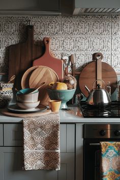 the kitchen counter is cluttered with dishes and utensils, including cutting boards